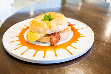 Fresh healthy bagel with egg and bacon for breakfast.