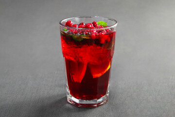 Berry cranberry tea with mint in a glass glass