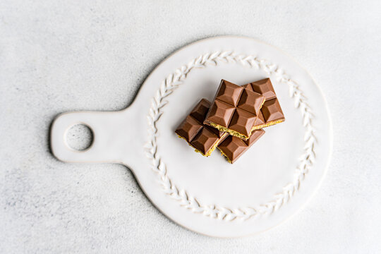 Overhead view of a Dubai chocolate bar filled with pistachio paste on a serving plate