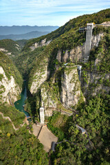 Scenic view from Zhangjiajie glass bridge, the world's longest and highest glass bridge. Green grand canyon with elevator in Wulingyuan area, Zhangjiajie, Hunan, China.