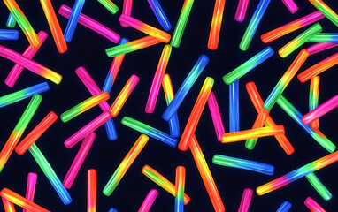 Vibrant and colorful glow sticks scattered randomly against a dark background, perfect for party or celebration themes.