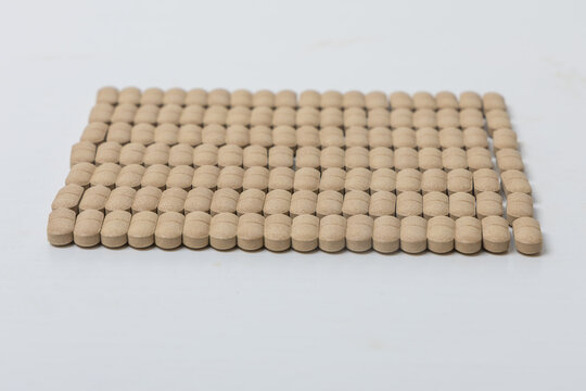 Oval brown pills as a dietary supplement on a white table