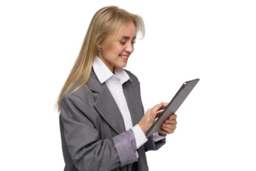 Young professional woman using tablet while smiling in a modern office environment