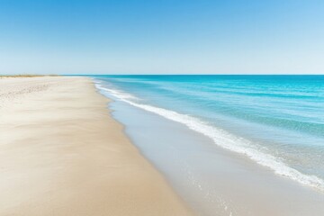 Fototapeta premium empty beach with pristine sand leading to turquoise waves set under clear blue sky featuring ample copy space for summer-themed
