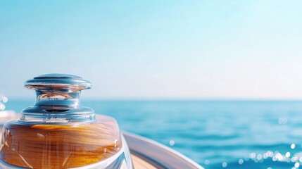 Obraz premium sunlit close-up of elegant yacht helm gleaming stainless steel and varnished wood in focus