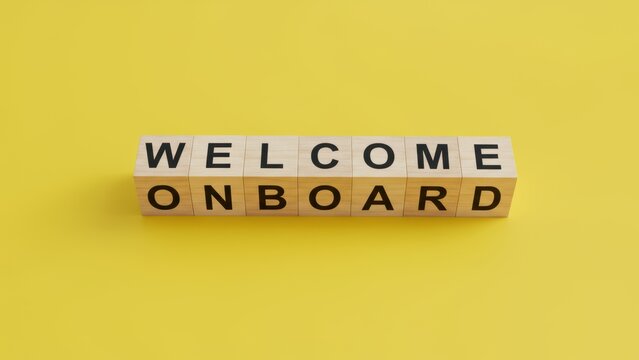 Wooden blocks spell welcome onboard on bright yellow background, conveying positive business message encouraging teamwork and integration