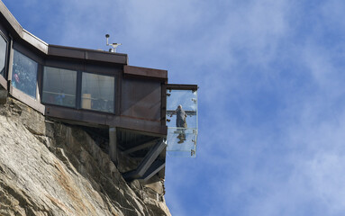 View from below of the Aiguille du Midi cable car station with the Step into the Void, a glass box, glazed on 5 sides, Chamonix, Haute Savoie, France