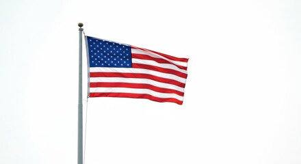 American flag waving proudly against a bright sky backdrop. The emblem of the USA gracefully blowing in the wind