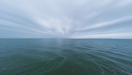 Serene Panoramic View of Tranquil Sea Under Dramatic Converging Clouds
