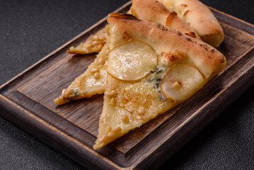 Delicious sweet pizza with pear, gorgonzola cheese and nuts