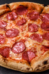 Pepperoni pizza with sausage, cheese, tomatoes, salt and spices