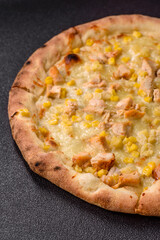 Hawaiian pizza with chicken, pineapple, corn and cheese