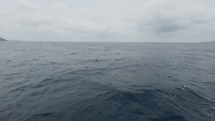 Side view from boat in Indian ocean sailing between Seychelles islands before storm