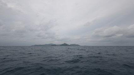Front view from boat in Indian ocean sailing between Seychelles islands before storm