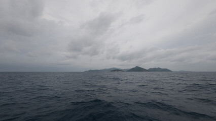 Front view from boat in Indian ocean sailing between Seychelles islands before storm