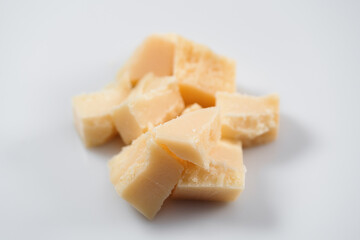 Parmesan cheese chunks on white background