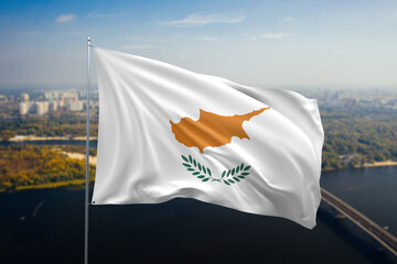 Cyprus National Flag Waving Proudly Against a Cityscape Backdrop