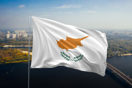 Cyprus National Flag Waving Proudly Against a Cityscape Backdrop