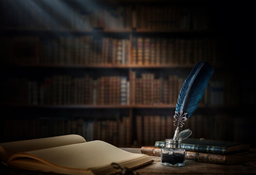Old quill pen with an inkwell, papers and books on a table against an old bookshelf. Concept on the theme of history, education, literature. Retro style.