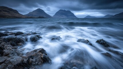 Fototapeta premium Dramatic coastal landscape with rocky shoreline and misty mountains under a stormy sky, showcasing the beauty of nature in a serene yet powerful atmosphere.