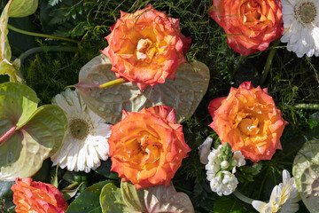 Orange roses and white gerberas creating a stunning floral arrangement