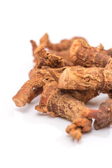 Dried galangal root isolated on white background, aromatic spice and herbal medicine concept