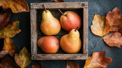 Four ripe pears in rustic wooden crate, surrounded by autumn leaves