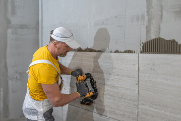 Tiling with large format tiles. A tiler expelling air from under the tile by a vibration suction...