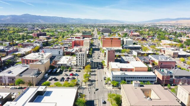 Aerial view of Missoula, Montana, along Broadway street with slow forward motion. Missoula is a city in and the county seat of Missoula County, Montana. It is located along the Clark Fork River.
