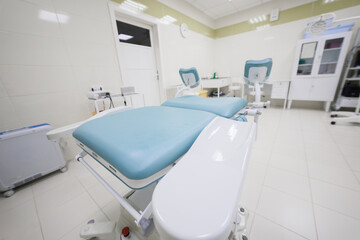 A clean, wellequipped medical examination room that features a comfortable treatment bed and modern facilities