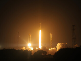 A rocket ascends into the night sky, symbolizing ambition and exploration