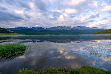 Beautiful reflection of Altai mountains in lake Dzhangyskol, Russia
