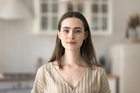 Independent and confident millennial. Head shot portrait profile picture at social media of young casual beautiful woman student freelance worker posing at home looking at camera talking by video call