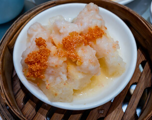 Steamed Shrimp Dumplings with Tobiko, fish roe, on top. A Cantonese Dim Sum cuisine popular in Hong Kong.