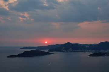 Fototapeta premium Pink glow of the setting sun over the mountains in the evening