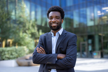 Portrait of successful confident businessman. Man in business suit smiling and looking at camera....