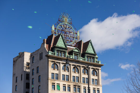 Scranton, PA - Mar 8, 2025: The Scranton Electric City Sign Building, a landmark building with green confetti swirling in the air