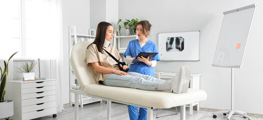 Injured young woman after accident with doctor in clinic