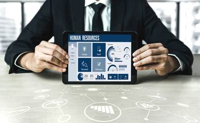 Human resources management software on computer screen helping human resources employee to manage recruitment, payroll, staff searching and KPI evaluation snugly