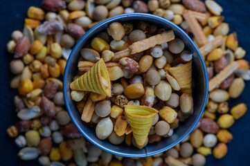 Colorful assortment of savory snacks arranged in a vibrant dish during a lively gathering