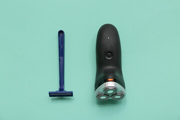 Razor and electric shaver on turquoise background. Concept of evolution