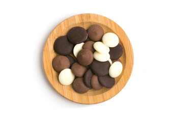 plate with chocolate drops on white background