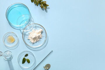 Petri dishes with samples of natural cosmetic products on light blue background