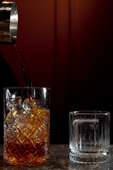 glass of whiskey with ice cubes 