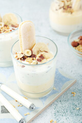 Milk mousse dessert with nuts in glasses