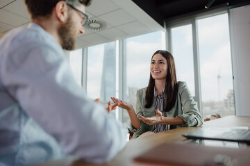 Professional Business Discussion Between Two Colleagues in a Modern Office Setting