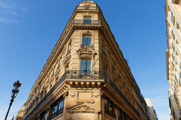 Exterior architecture of Traditional French house with typical balconies and windows in Paris. France.
