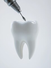 A dental drill approaches a white tooth for treatment