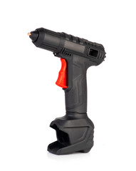 Cordless hot glue gun isolated on a white background. Black and red ergonomic design with a trigger...