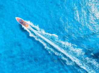 Drone view on fast boat on blue Mediterranean sea at sunny day. Vacation and leisure. Fast ship on...